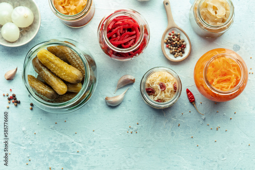 Fermented food, shot from above with copy space. Homemade vegetable preserves. Sauerkraut, pickles, kimchi etc in glass jars. Healthy probiotic diet
