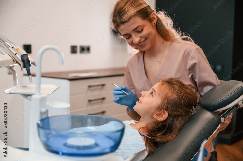 Woman is working with little girl teeth. In the stomatological cabinet Woman is working with little girl teeth. In the stomatological cabinet