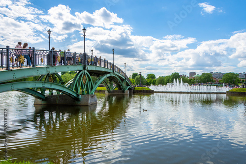 Tsaritsynsky park in Moscow on a sunny summer day. View of the river with reflection and bridge. Tsaritsynsky Park is one of the main tourist attractions in Moscow. photo