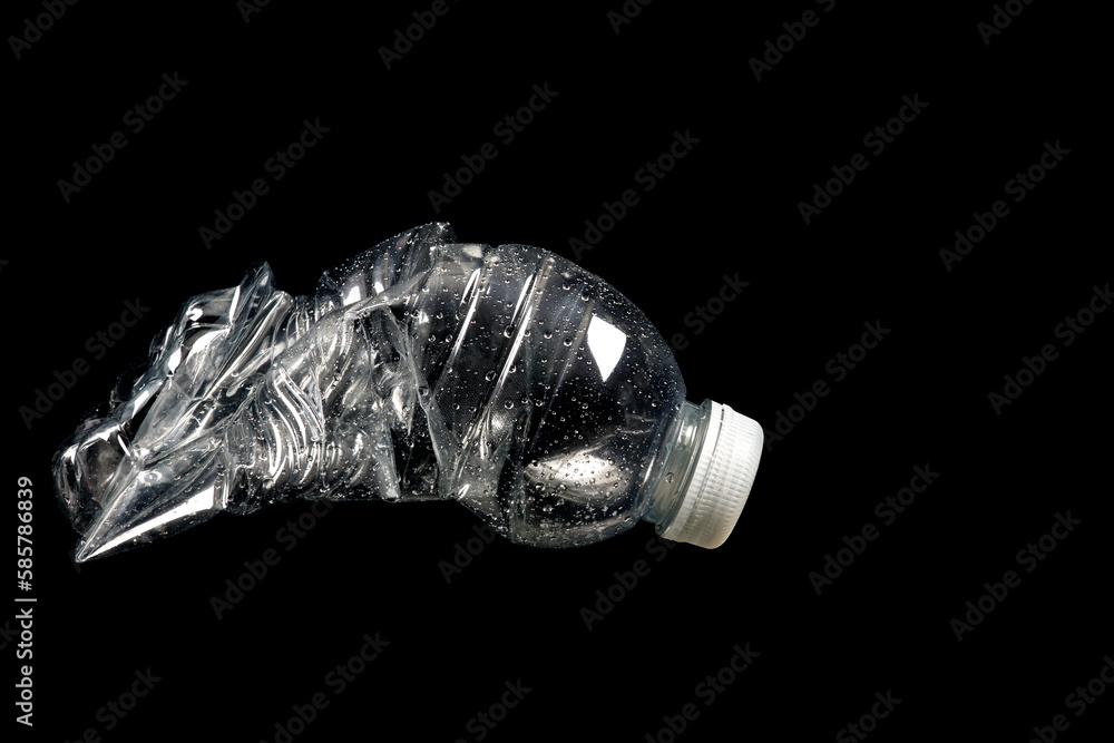 Crushed Plastic Mineral Water Bottle on a Black Background Crushed Plastic Mineral Water Bottle on a Black Background