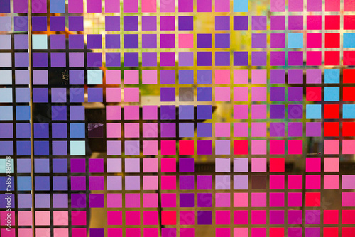 Mosaic of small multi-colored squares on glass, close-up. Matrix style multicolored digital squares.