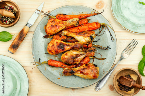Roasted chicken drumstick with carrots.