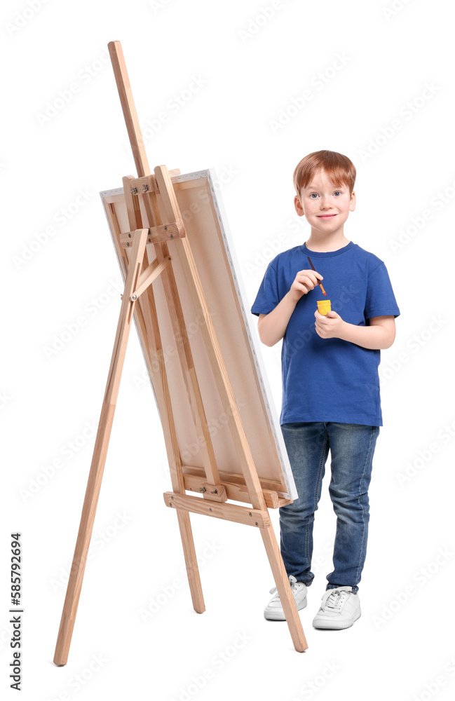 Little boy with brush near easel with canvas on white background. Creative hobby Little boy with brush near easel with canvas on white background. Creative hobby