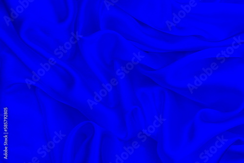 Satin beautiful blue silk fabric lies with drapery. 