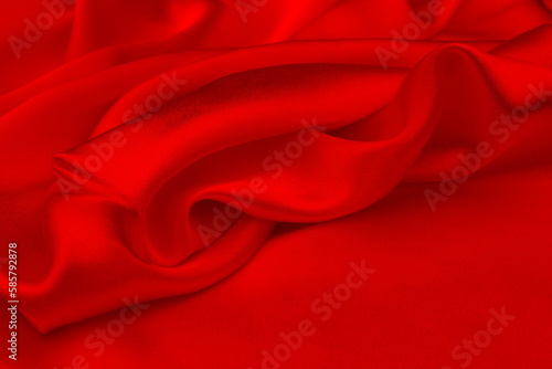 The satin red fabric lays beautifully draped.