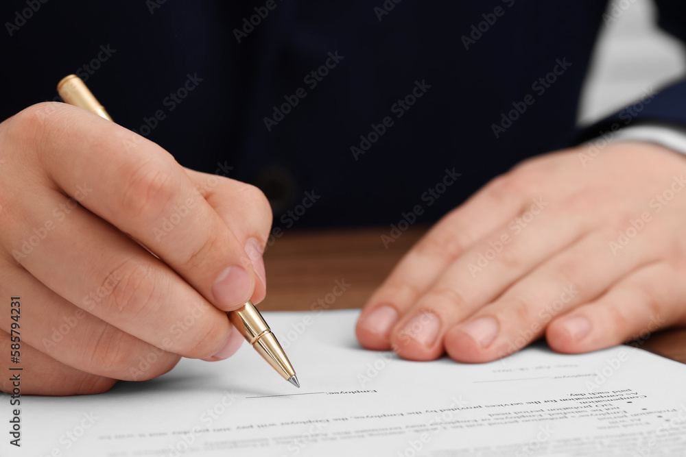 Man signing document at table, closeup view Man signing document at table, closeup view