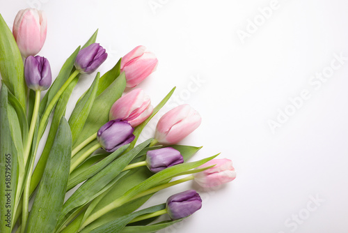 Fototapeta Naklejka Na Ścianę i Meble -  Beautiful tulips on light background, flat lay. Space for text