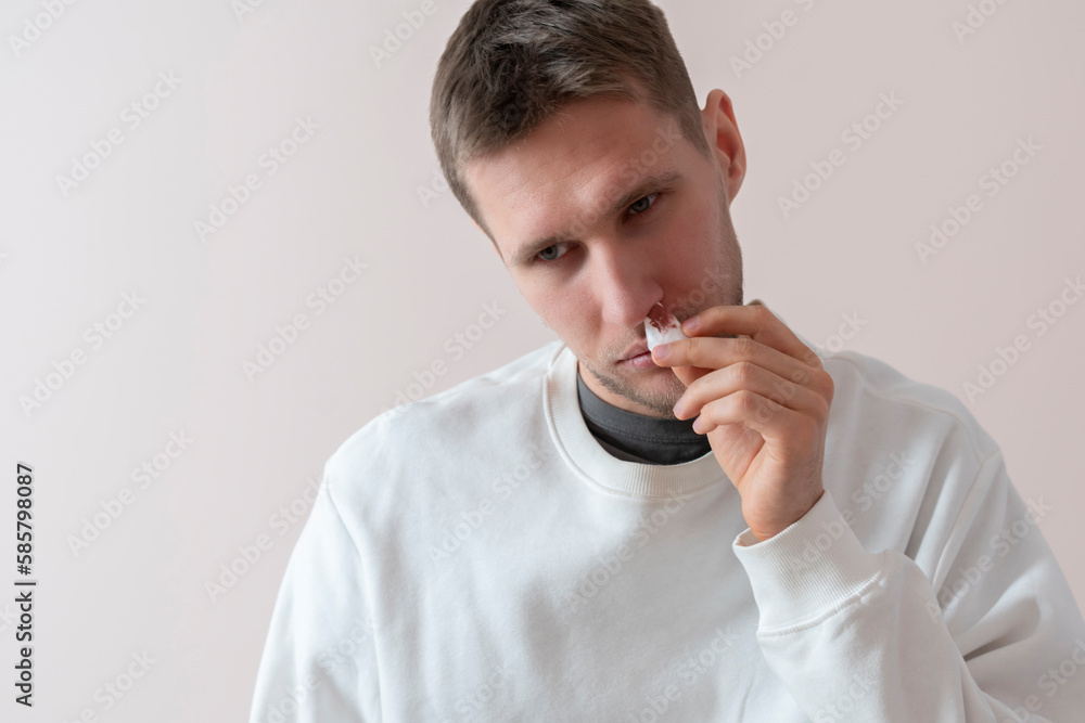 young man has broken nose with blood going out it and stop it with a napkin, unfortinate accident young man has broken nose with blood going out it and stop it with a napkin, unfortinate accident