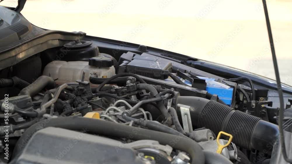 mechanic closes the bonnet after checking the electrical system.car service center mechanic closes the bonnet after checking the electrical system.car service center