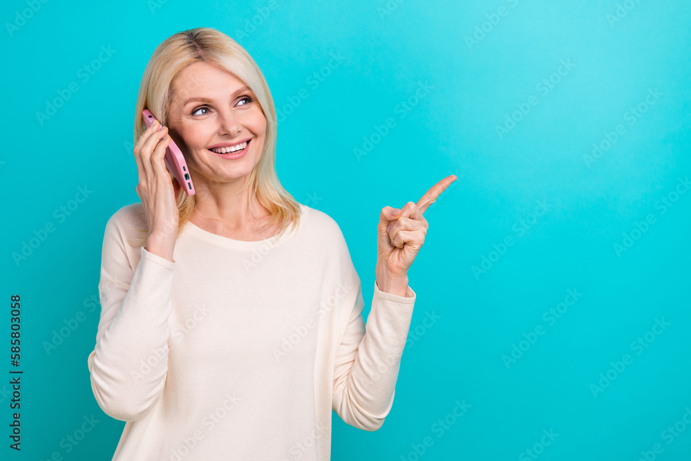 Photo of pretty dreamy lady dressed white shirt talking modern gadget showing empty space isolated teal color background Photo of pretty dreamy lady dressed white shirt talking modern gadget showing empty space isolated teal color background