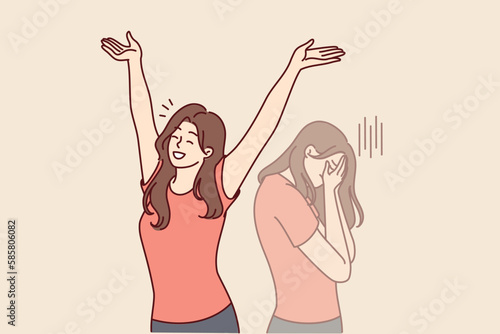 Positive woman raises hands up and rejoices having got rid of bad emotions and depression spoiling mood. Crying doppelganger behind girl for concept of mood swings or split personality