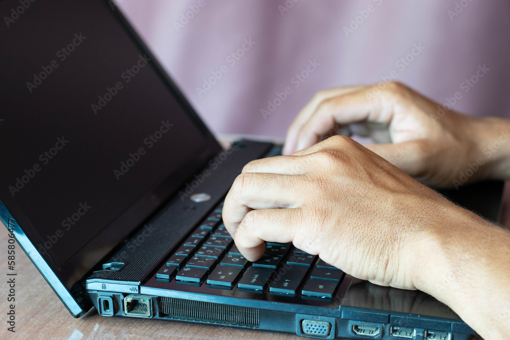 Close-up shot of two male hands working at home with laptop and mobile smart phone, network technology, no thumbs up, great working. Close-up shot of two male hands working at home with laptop and mobile smart phone, network technology, no thumbs up, great working.