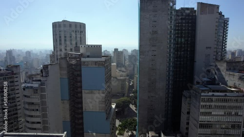 Aerial view rising over streets, past the Edifício Copan, in Republica, Sao Paulo, Brazil photo