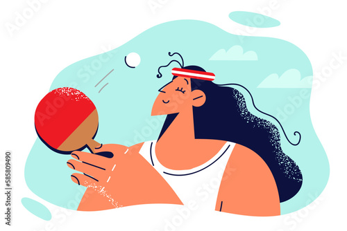 Relaxed woman playing table tennis with racket during match with opponent or training before game