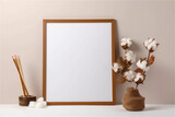 empty wooden frame mockup and cotton flower on beige background, interior with natural light .