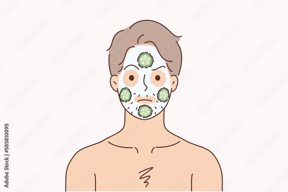 Man do face mask with cucumbers 