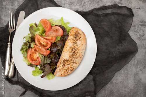 Baked turkey with vegetable fresh salad on plate