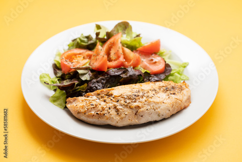 Baked turkey with vegetable fresh salad on plate