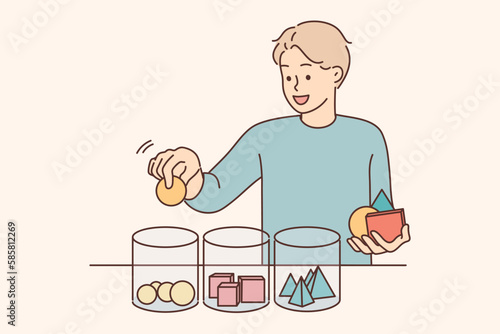 Smiling child sort geometric figures in jars 