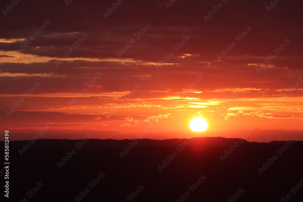 Fototapeta premium red sun comes down landscape