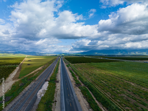 Highway Stretched between Fields, Dappled with Cloud Shadows
