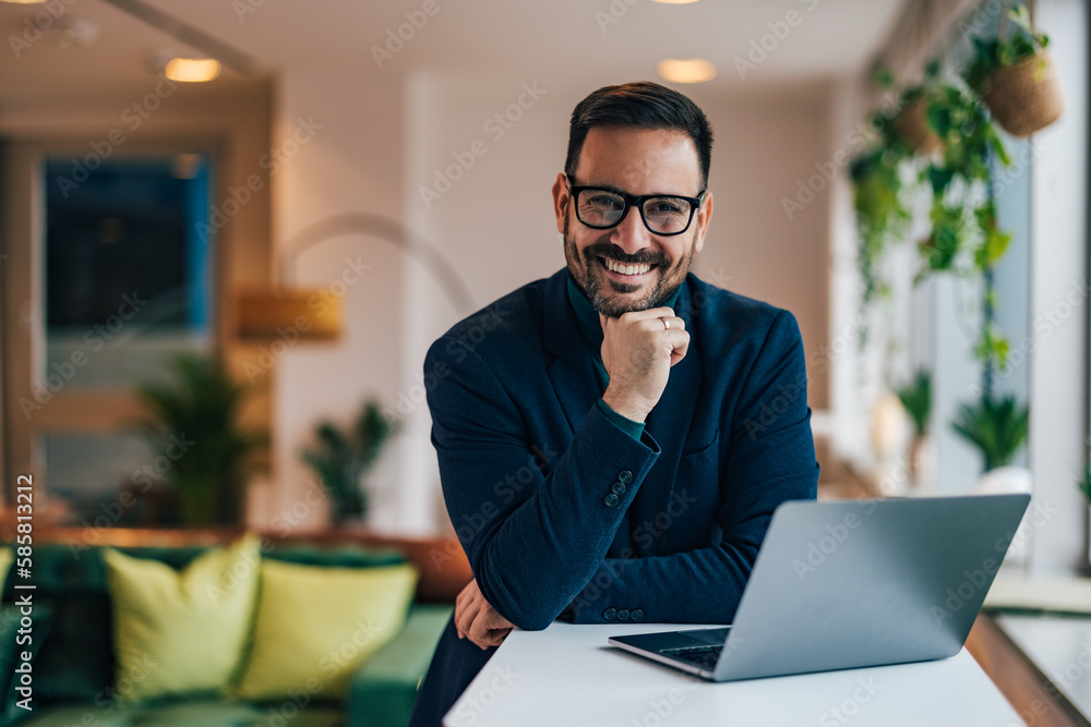 Portrait of a smiling businessman working over the laptop. Portrait of a smiling businessman working over the laptop.