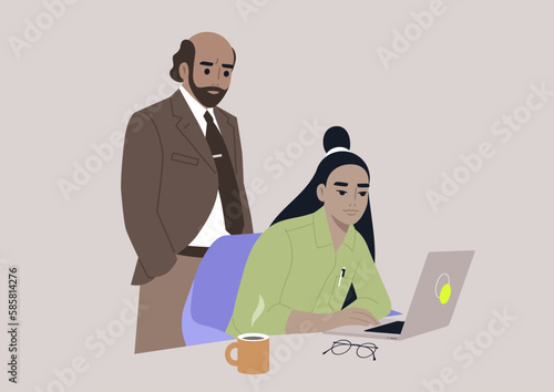 A senior manager supervising an intern in the office