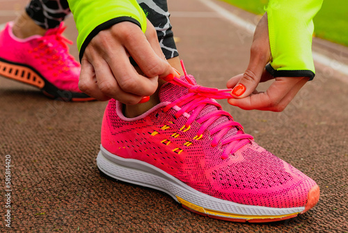 Close-up of running shoes on a woman's feet. A woman during a workout outside at the stadium