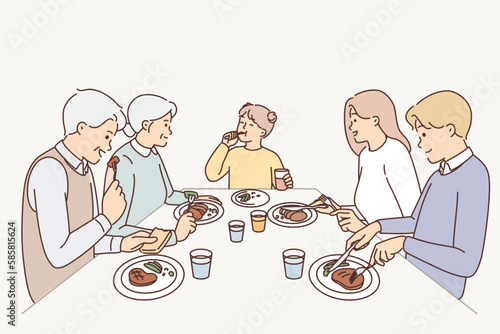 Big family eating dinner at table 