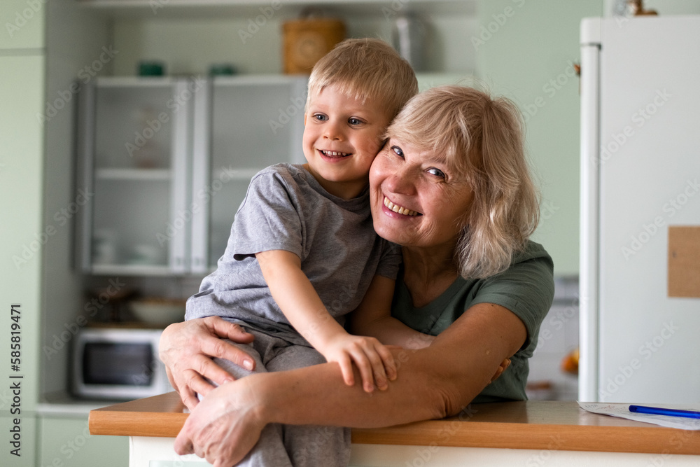 Happy family - grand mother hugs with grandson at home Happy family - grand mother hugs with grandson at home