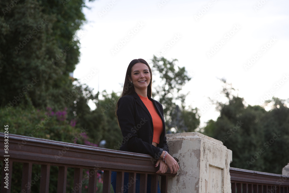 pretty young Spanish woman looking over the railing to the horizon. The woman is happy and content because she looks to the future with interest. pretty young Spanish woman looking over the railing to the horizon. The woman is happy and content because she looks to the future with interest.