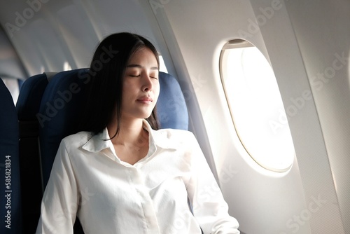 Woman sleeping on a plane while traveling
