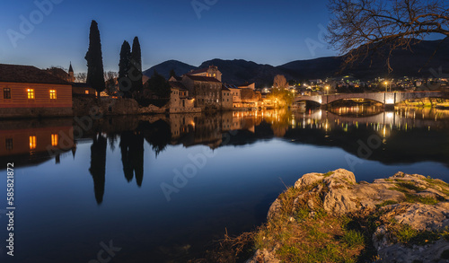 Night cityscape. Trebinje is a city in Bosnia and Herzegovina, the historical center of the city. Buildings are reflected in the river