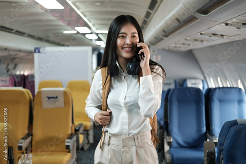 Backpacker asian woman in the airplane while to destination. Travel concept