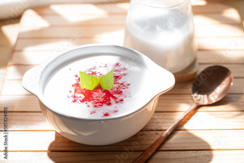 Pearl Porridge or pearl sago. Popular Indonesian desserts are commonly encountered during the month of Ramadhan. Served in a ceramic bowl with pandan leaves.