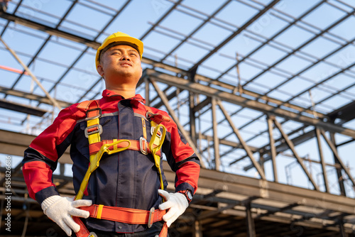 Asian worker wear safety height equipment to install the roof. Fall arrestor device for worker with hooks for safety body harness, Worker as in the construction site