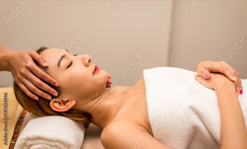 Relaxing with hand massage at beauty spa. Soothing massage, hand of professional massage therapist. Mental health.