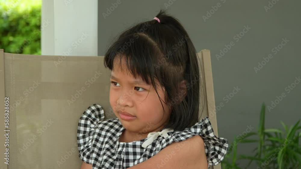 Portrait of Asian angry, sad and cry little girl, The emotion of a child when tantrum and mad, expression grumpy emotion after refrain from using tablet. Kid emotional control concept Portrait of Asian angry, sad and cry little girl, The emotion of a child when tantrum and mad, expression grumpy emotion after refrain from using tablet. Kid emotional control concept