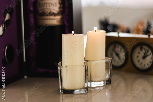 Lit candles in glass containers
