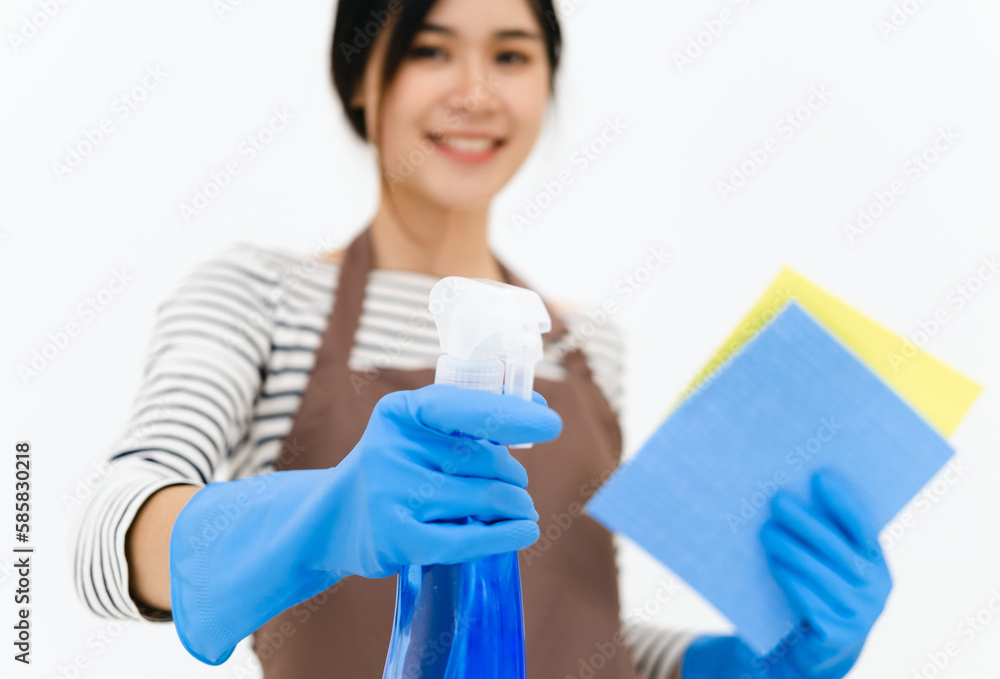 Happy asian woman in blue gloves smiling while posing with sponge and spray bottle. portrait looking at camera . isolated on white background. Happy asian woman in blue gloves smiling while posing with sponge and spray bottle. portrait looking at camera . isolated on white background.