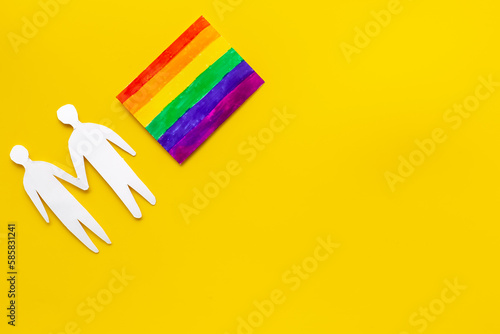 Gay pride rainbow LGBT flag with men couple paper shapes. LGBT social rights concept.