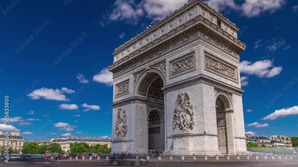 The Arc de Triomphe (Triumphal Arch of the Star) timelapse hyperlapse with traffic on a circle road. Famous monument in Paris, standing at the western end of the Champs-Elyseees. Blue sky at summer The Arc de Triomphe (Triumphal Arch of the Star) timelapse hyperlapse with traffic on a circle road. Famous monument in Paris, standing at the western end of the Champs-Elyseees. Blue sky at summer
