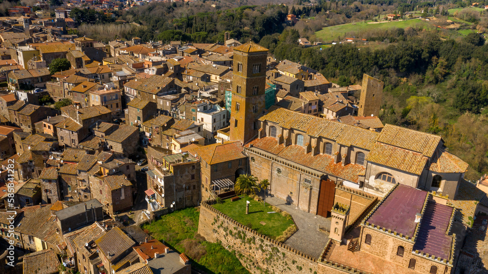 Aerial view of the cathedral Santa Maria Assunta in the historic center of Sutri, town located near Viterbo and Rome, Italy. The Romanesque church with its bell tower dominates the city.