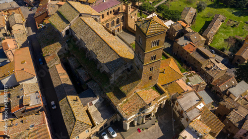 Aerial view of the cathedral Santa Maria Assunta in the historic center of Sutri, town located near Viterbo and Rome, Italy. The Romanesque church with its bell tower dominates the city.