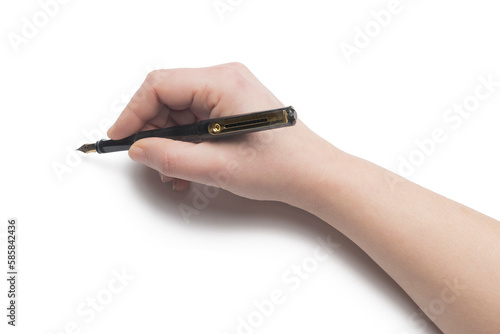 Woman's hand writes using a fountain pen