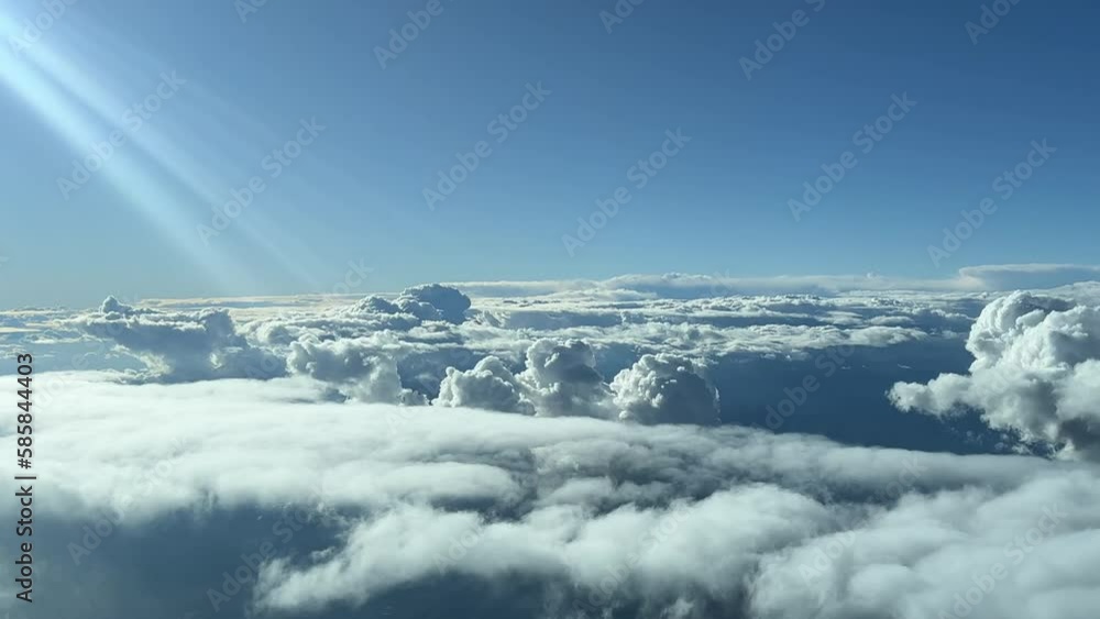 A pilot’s point of view: flying over a stormy sky with sunbeans on the left side. Flying at 12000m high. A pilot’s point of view: flying over a stormy sky with sunbeans on the left side. Flying at 12000m high.