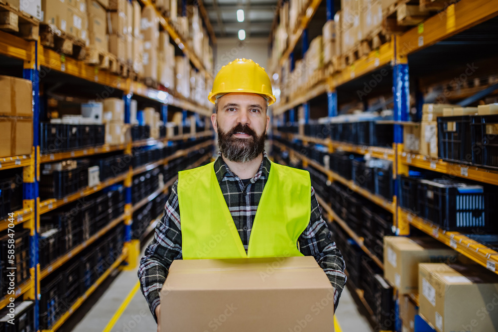 Warehouse worker stocking goods in a warehouse. Warehouse worker stocking goods in a warehouse.