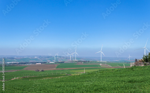 wind turbines generating energy from the wind, in nature, clear blue sky