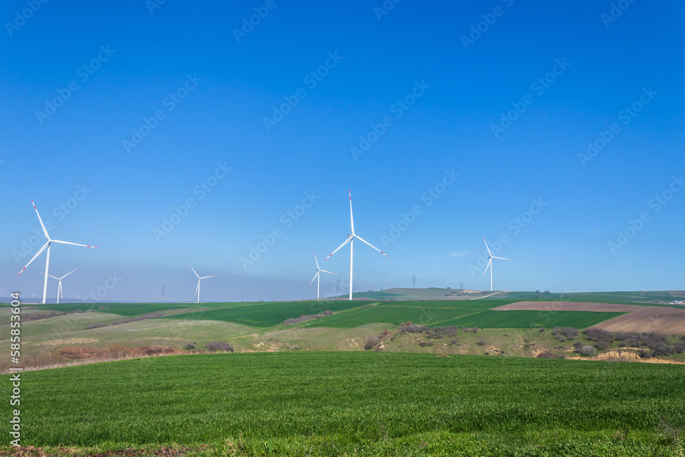 wind turbines generating energy from the wind, in nature, clear blue sky wind turbines generating energy from the wind, in nature, clear blue sky