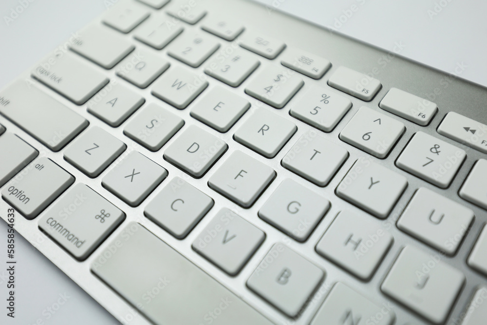 Gray keyboard with white buttons. Wireless keyboard. Computer components. Text input device. Keyboard on a white background Gray keyboard with white buttons. Wireless keyboard. Computer components. Text input device. Keyboard on a white background